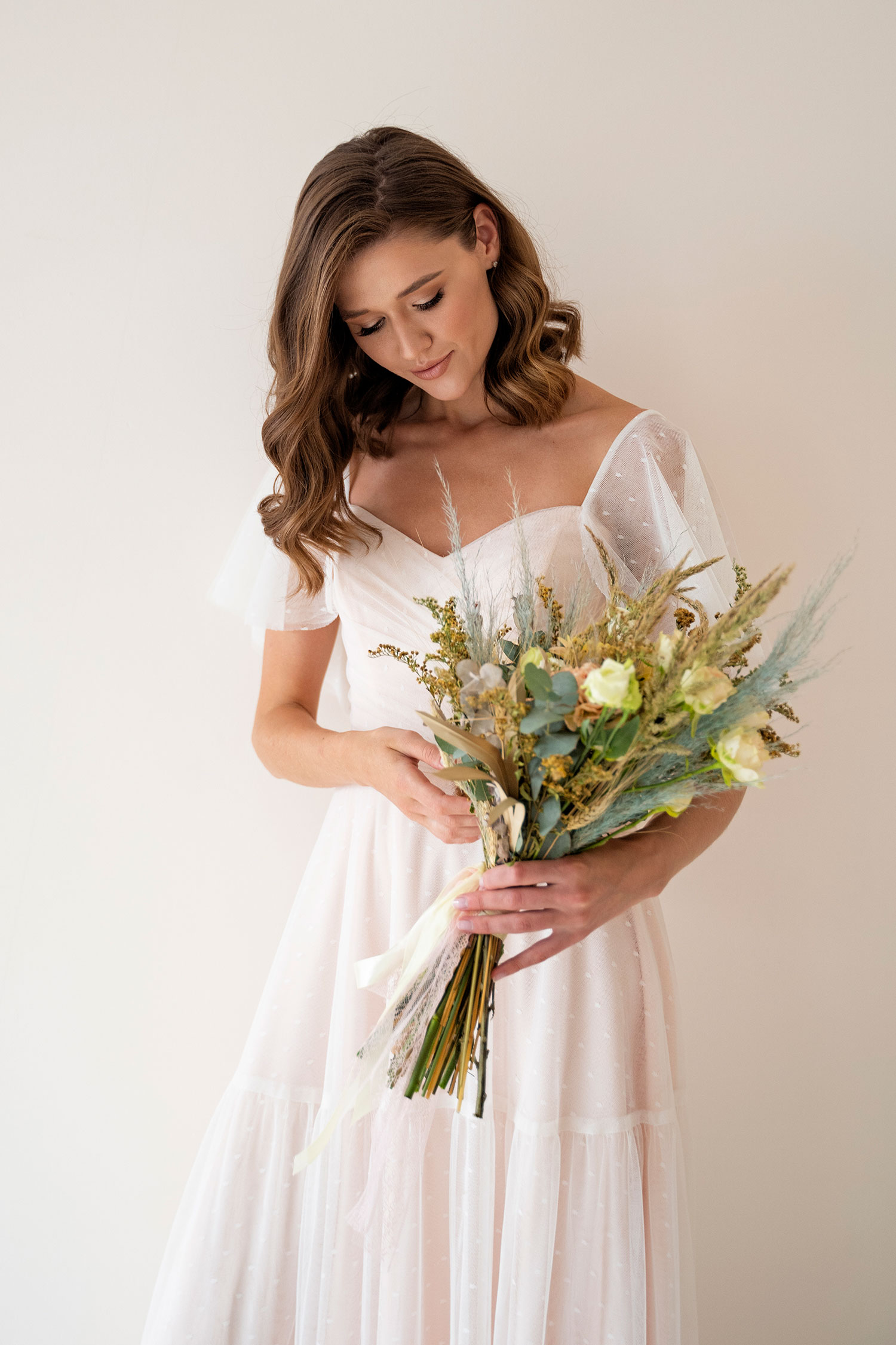 beautiful-bride-holding-flowers-front-view