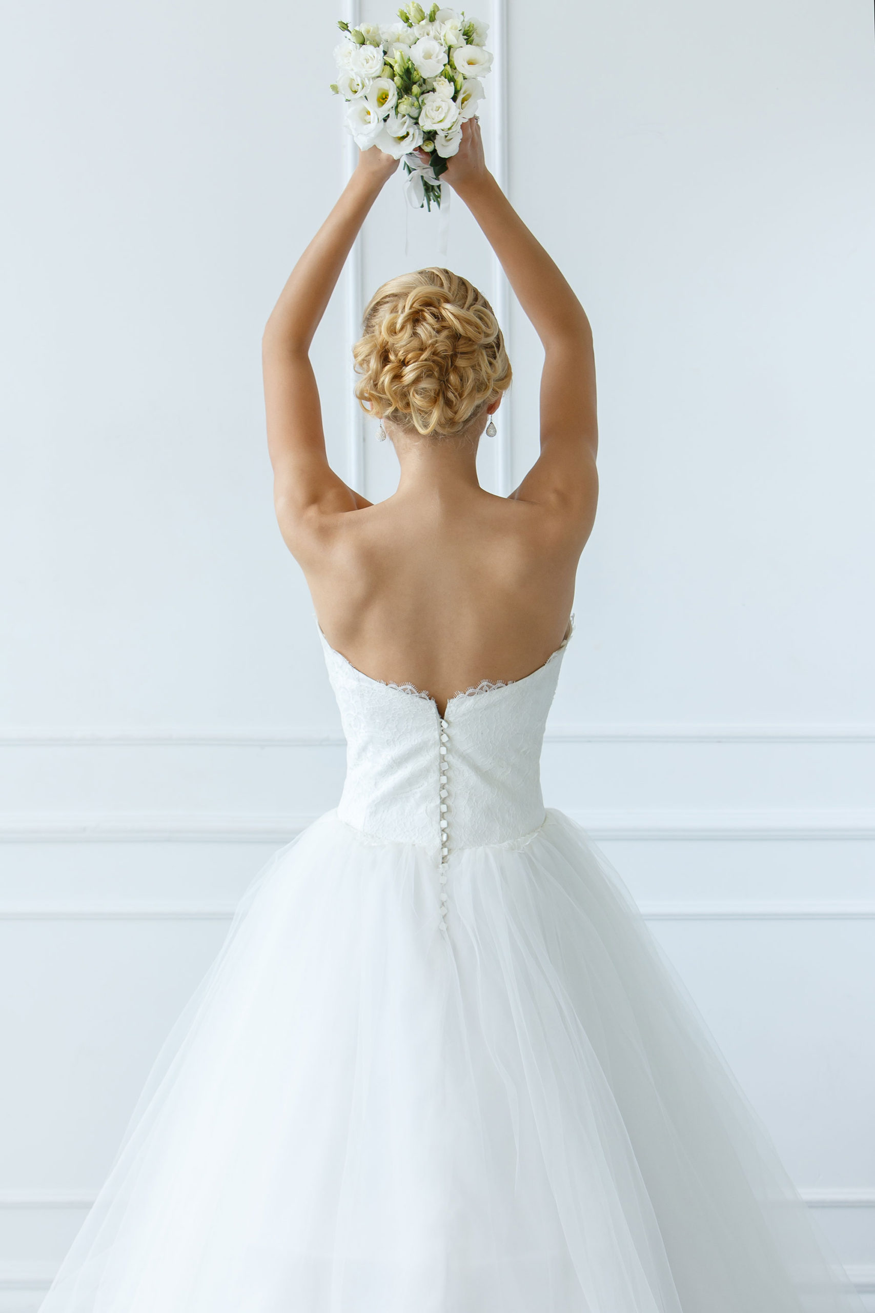 Wedding. Attractive bride throw beautiful bouquet